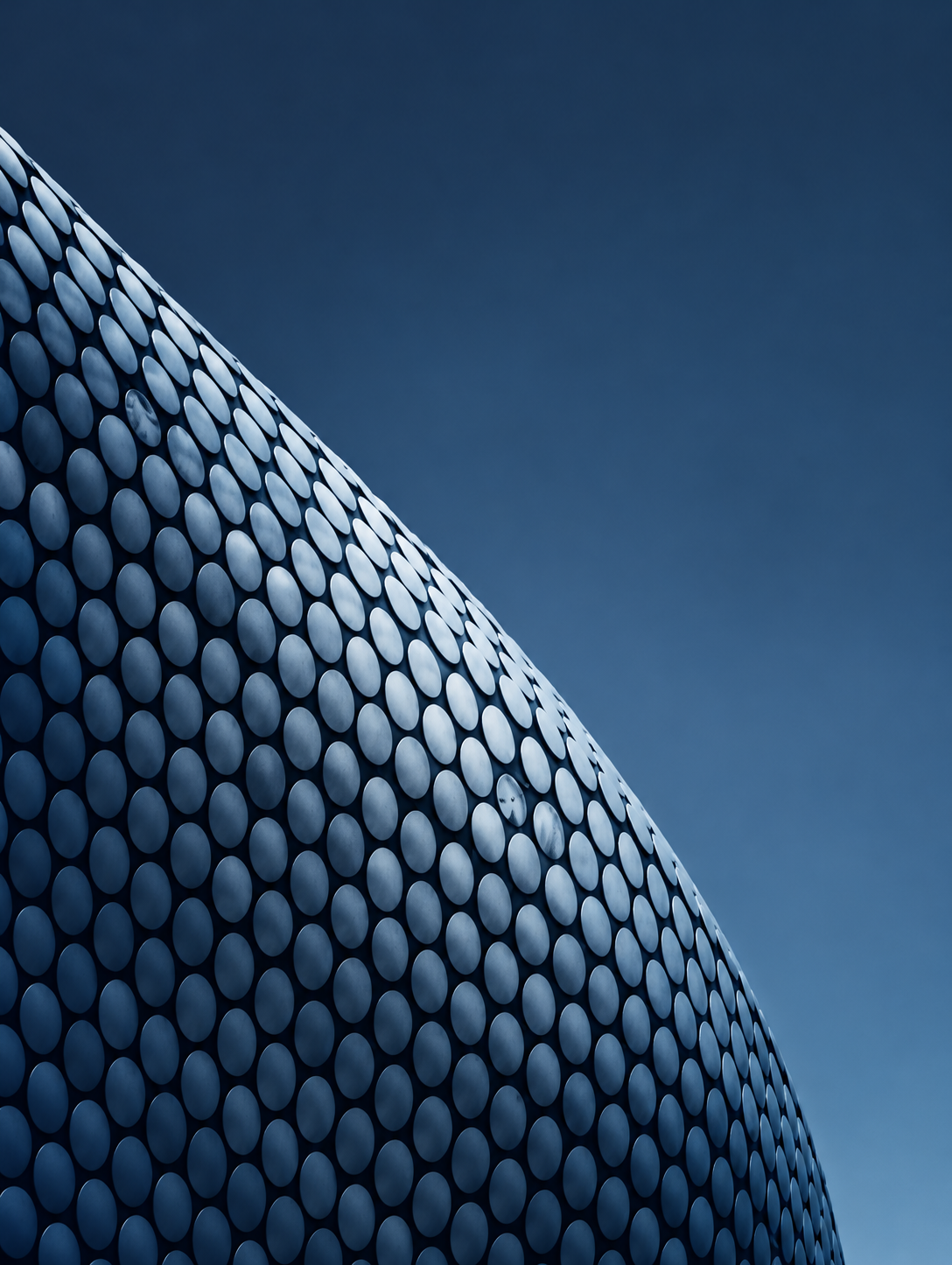 Curved Disc-Clad Facade Against Blue